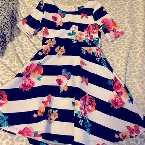 This dress is white and black striped has really pretty pink and blue flowers.